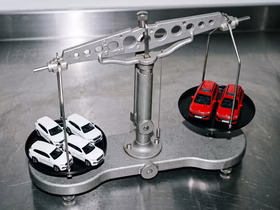 Весы с игрушечными машинками красного и белого цвета