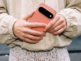 Смартфон Google Pixel 11 Pro кораллового цвета в руках женщины