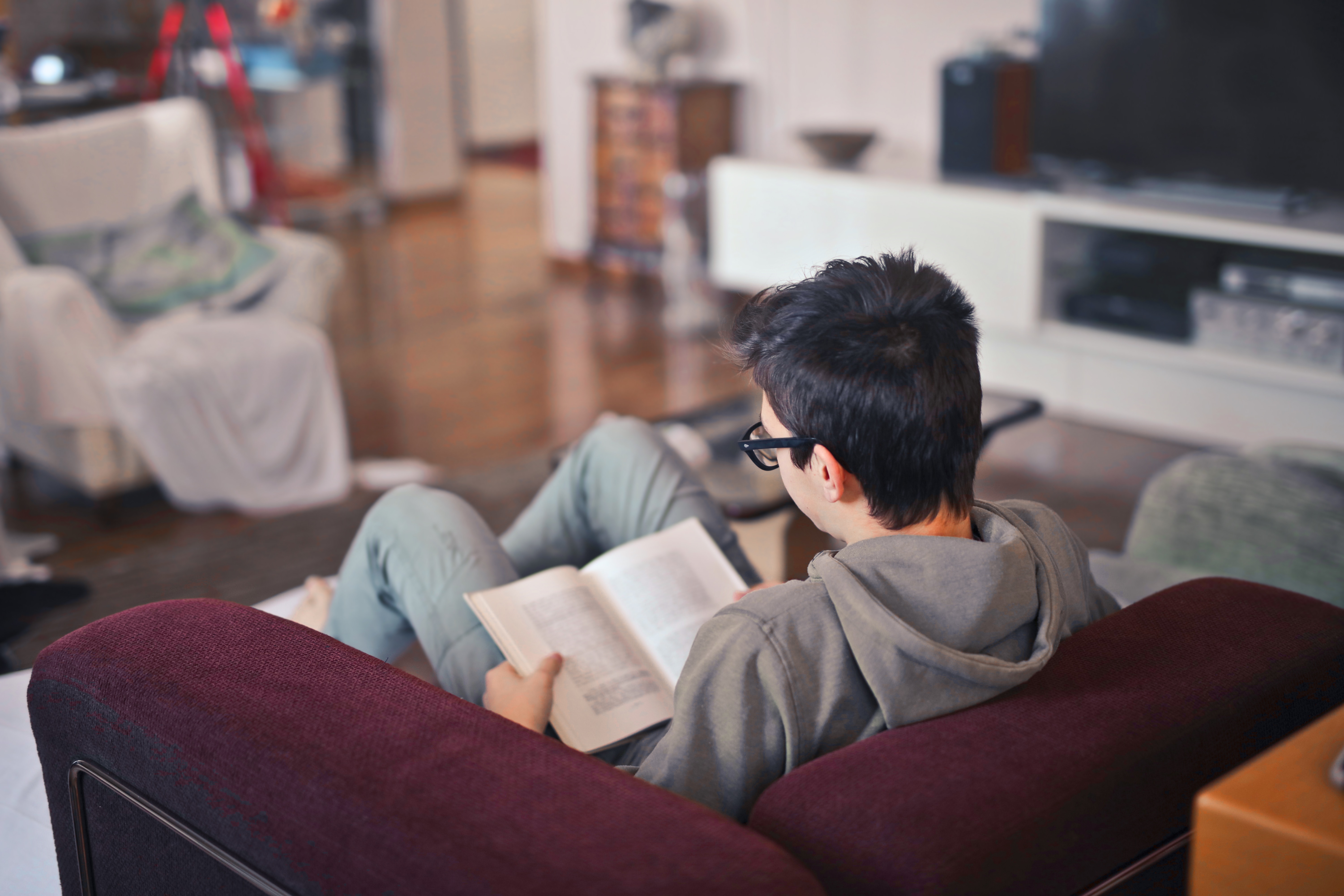 More than reading. Man in the Sofa reading a book. Book reading Armchair.